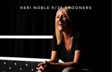 Event poster featuring a smiling blonde woman in a black top with layered necklaces, against a dark background; reads 'KERI NOBLE 9/26 CROONERS'.