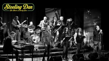 Live band on stage with a keyboardist, brass players, and vocalists; logo reads 'Steeling Dan' in the top left corner.