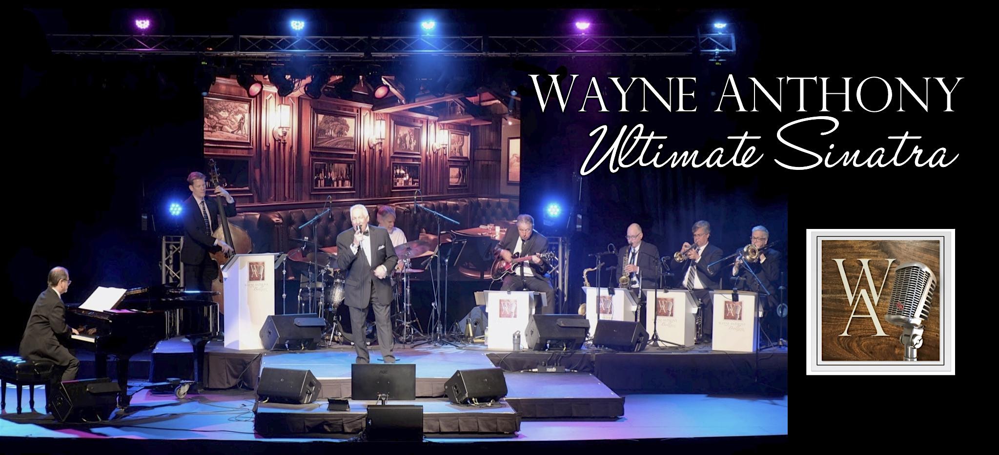 Stage performance by Wayne Anthony Ultimate Sinatra, with a jazz band and singer under colorful lights.
