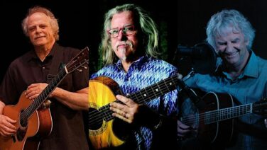 Three older men playing acoustic guitars on a dark stage, shown in a three-panel collage; they smile as they perform Nearby.